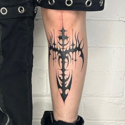 Unique blackwork tribal tattoo featuring a cross and cyber sigil, by Zanzi La Vey. Explore cyber sigilism in body art.